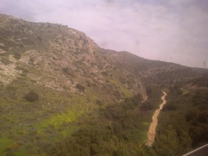 A mountain trail in the countryside, seen from the train window.