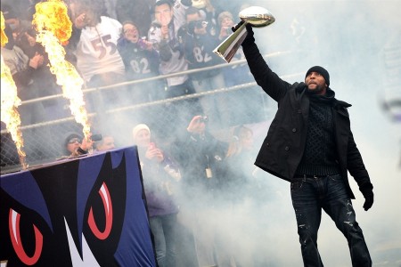 the Ravens' Ray Lewis Hoists the 2013 Lombardi Trophy after the Super Bowl
