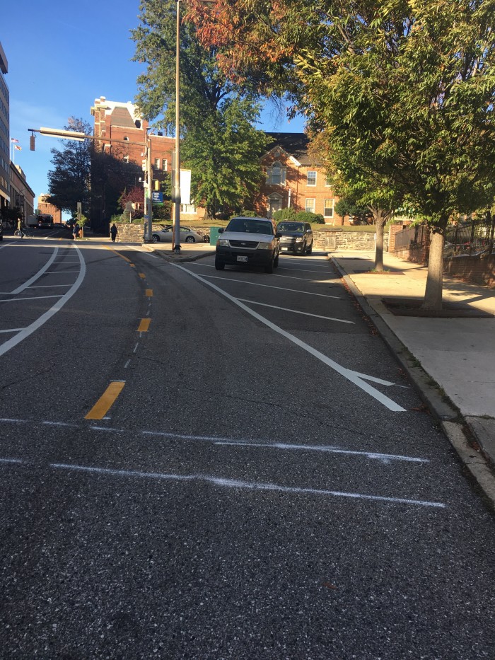 Cars cross several white lines to turn into the two way bike lane. It is inexcusable that this turnoff is not closed and this dangerous situation is allowed to exist.