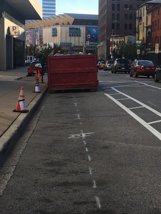 Another dumpster in the same bike lane a block south of the first dumpster.
